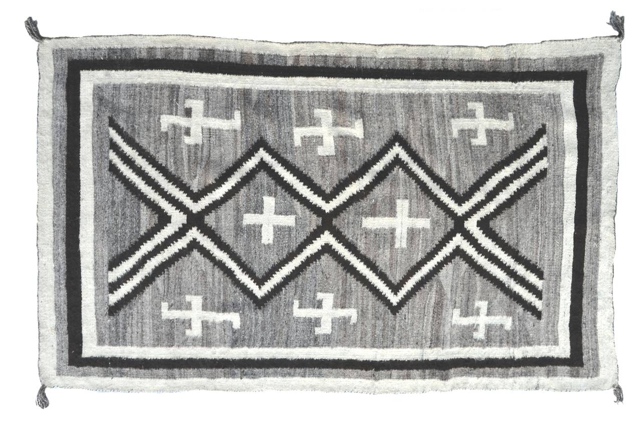 Beautiful antique J.B. Moore of Two Grey Hills Navajo wool rug with Spider Woman and Whirling Logs motives, circa 1900. This rug's look and soft hand-feel make would make it a fantastic addition either on floor or wall for a modern or cabin-like