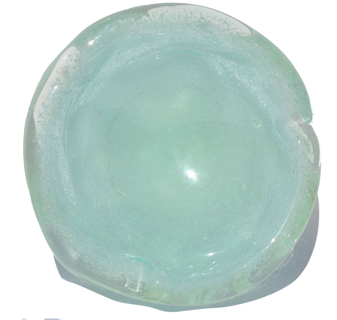 A Seguso seaform green handblown Murano glass ashtray or bowl with a lot of bubble inclusions done in the pelugoso technique. This exceptionally fine example of free-form Italian glass features a million bubbles and free-form knurled sides. The