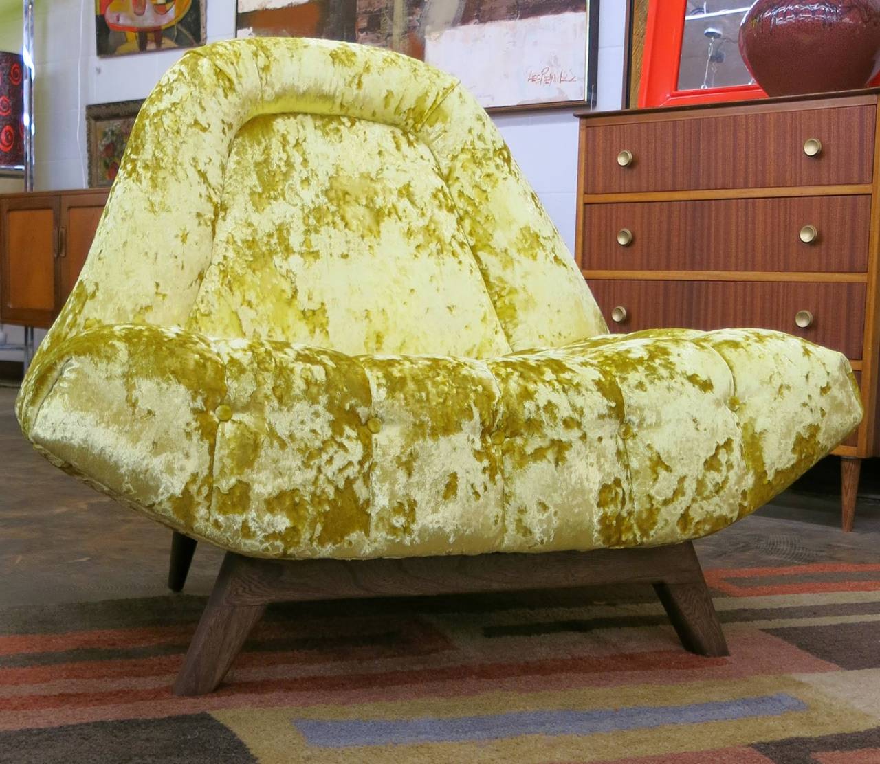 This Mid-Century Modern Adrian Pearsall gondola chair has been reupholstered in an acid yellow heavy crushed velvet reminiscent of the psychedelic 1960s. The seat is heavily tufted and the walnut legs have been refinished.