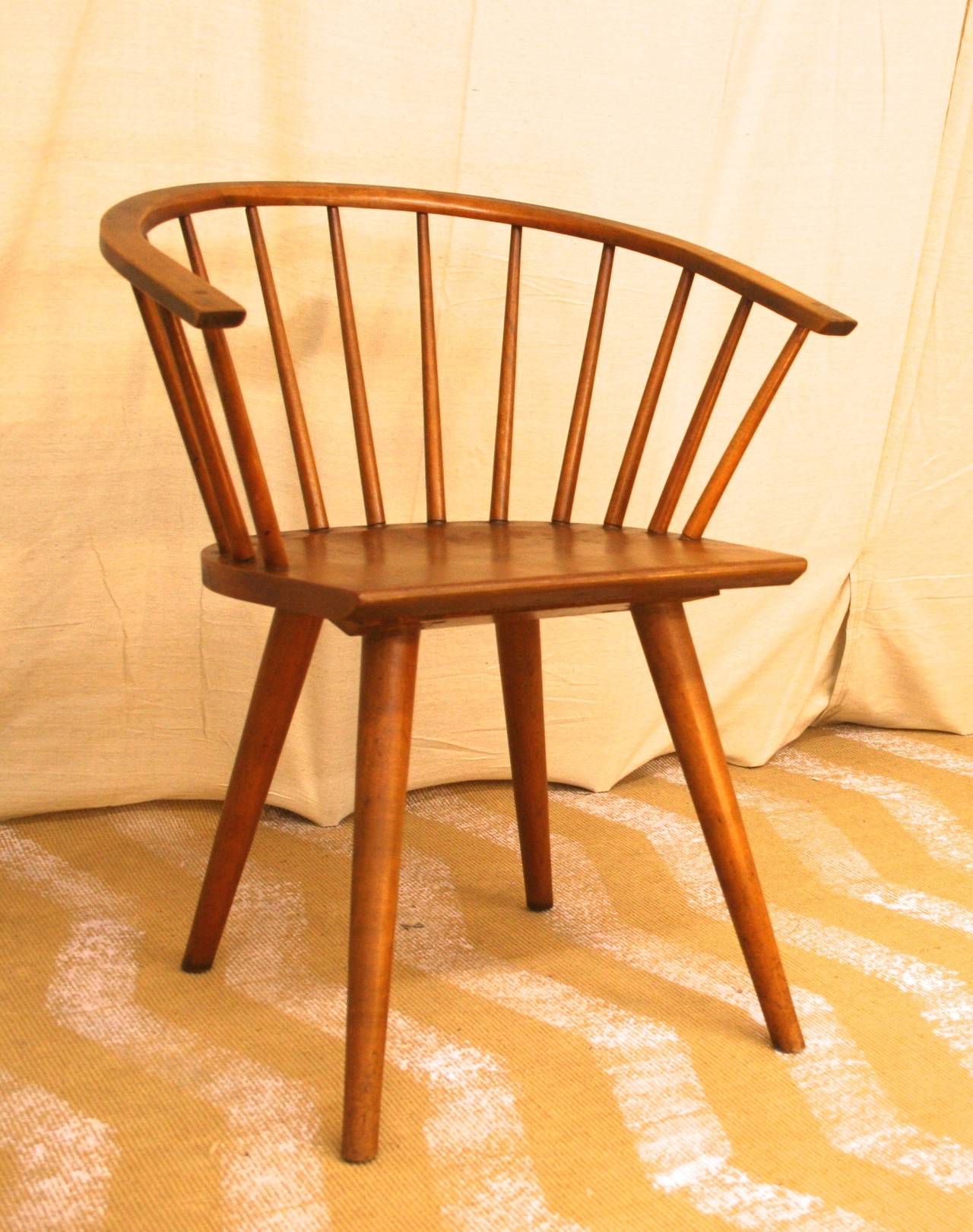 Pair of Windsor-style dining chairs by Conant Ball with curved back and spindles made of maple, circa 1950s.