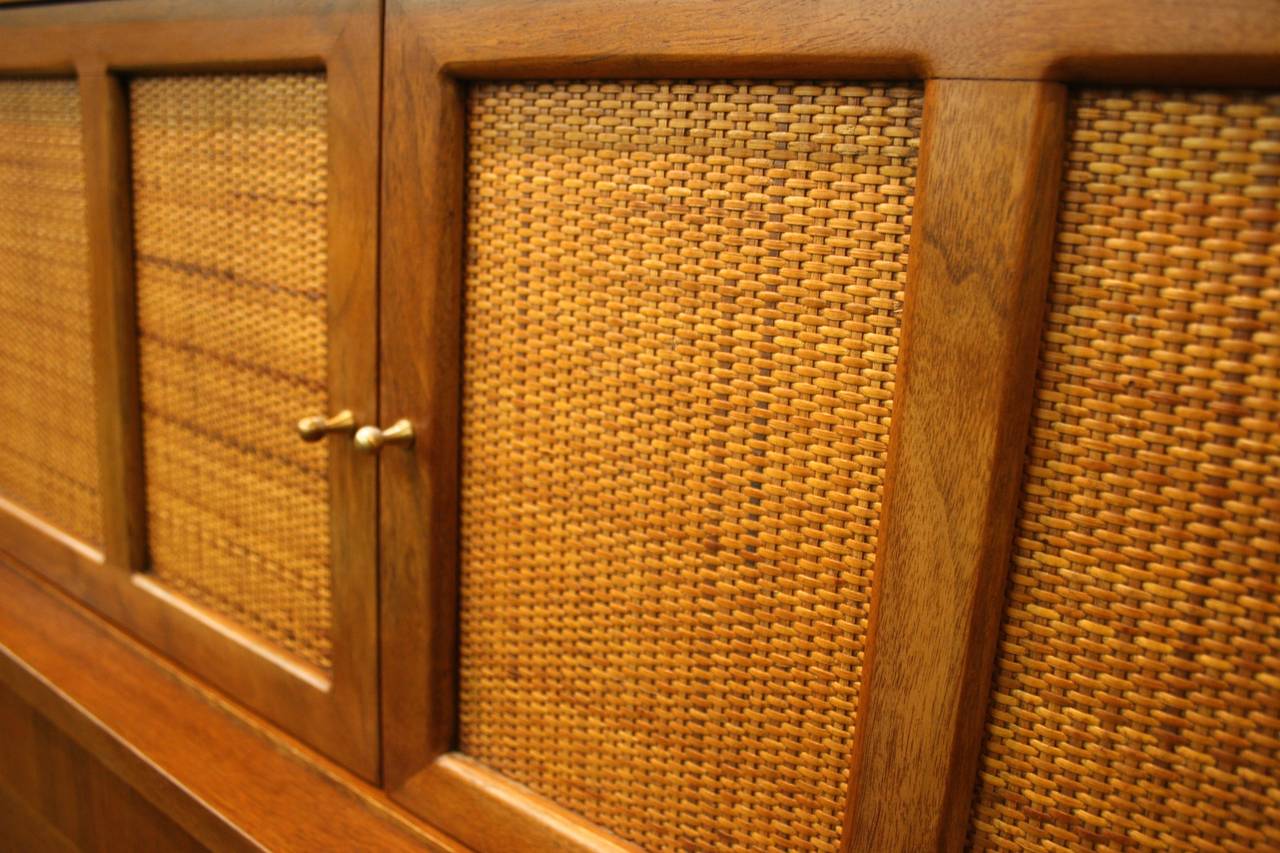 Designed to hold a gentleman's clothing, accessories and accoutrements, this American of Martinsville Gentleman's chest features elegant details and understated masculinity. The top section doors, featuring woven cane fronts, open to two drawers for