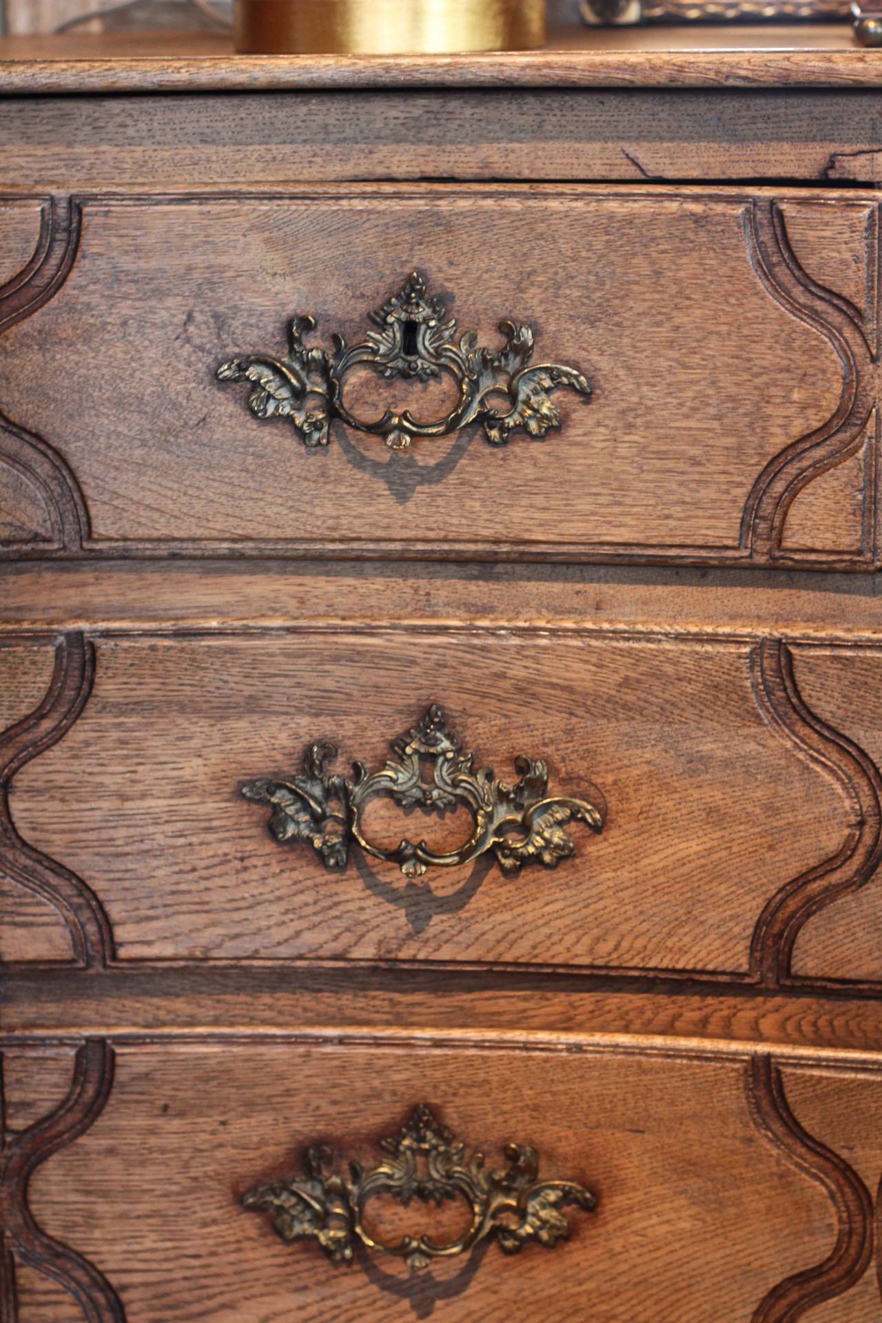 Two on two drawer, weathered oak serpentine commode. With carved apron and paneled sides.