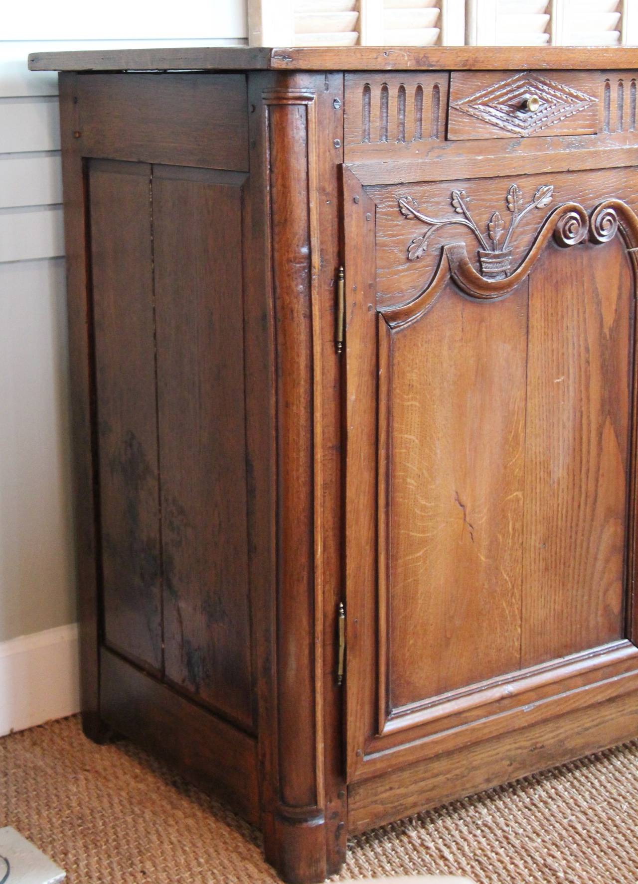 19th century oak enfilade with floral carving and fluted detail. Three drawers on three doors.