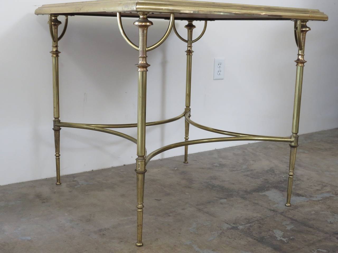 1950s French table in brass with leather details.
