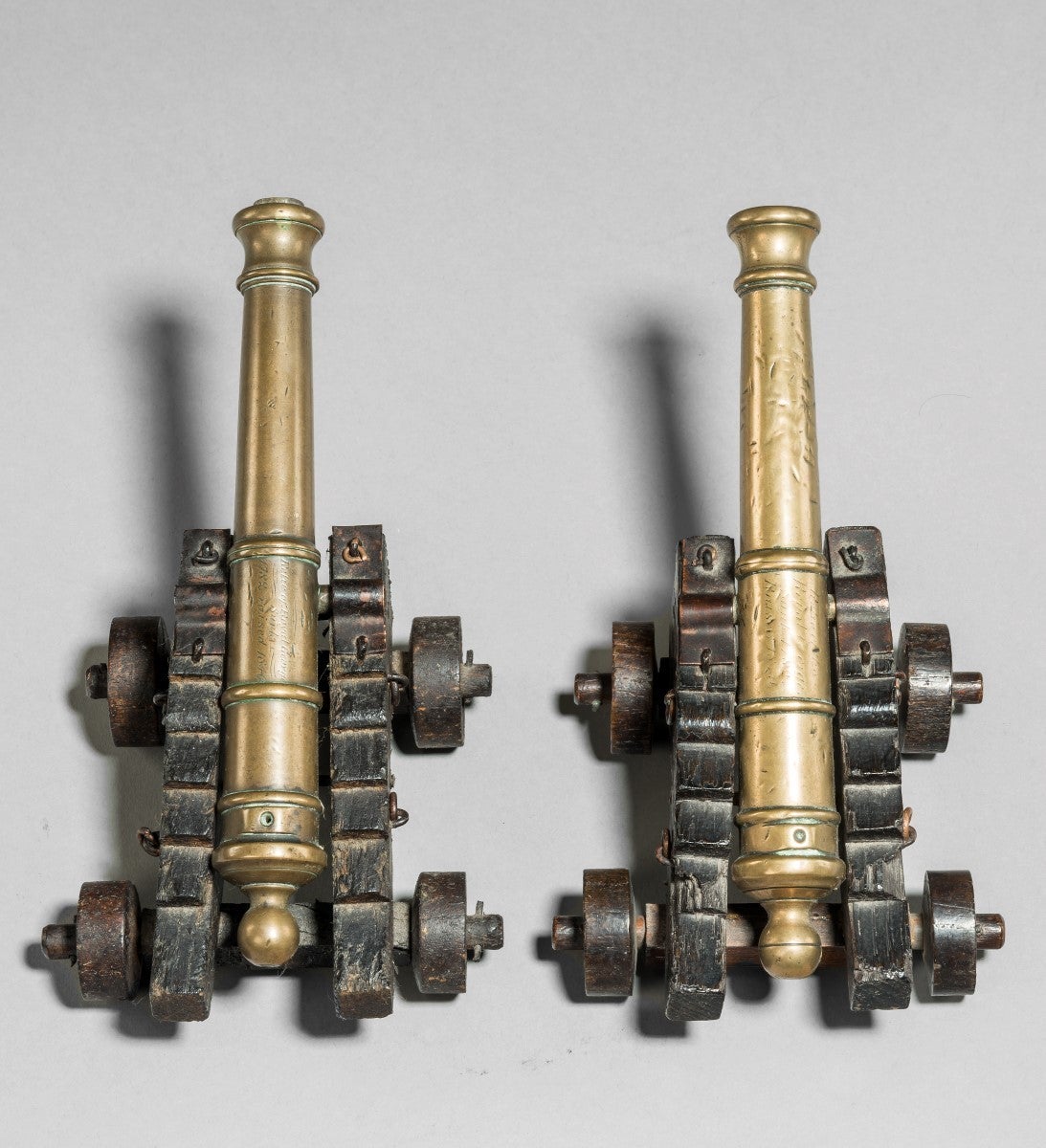 This pair of cannons on oak carriages was made in 1840 from the recovered salvage of the wreck of HMS Royal George to commemorate the disastrous sinking of the ship in 1782. Both of the barrels are inscribed in copper-plate script, one reading: