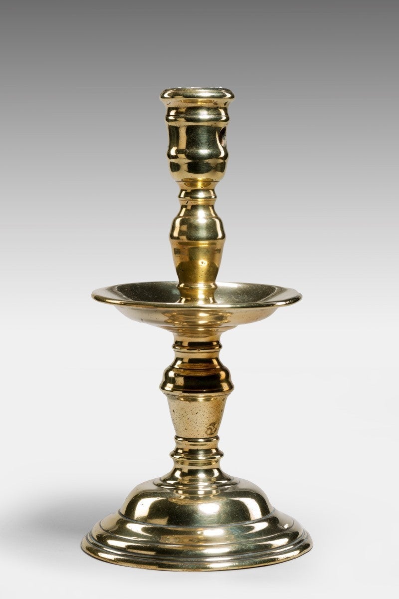 England/Holland.

With a deep basin-like drip pan. This Heemskerk candlestick has ridged ball knops, which were used from circa 1620-50, indicating the date as the Heemskerk forms seldom ever trespassed outside the shapes of their particular