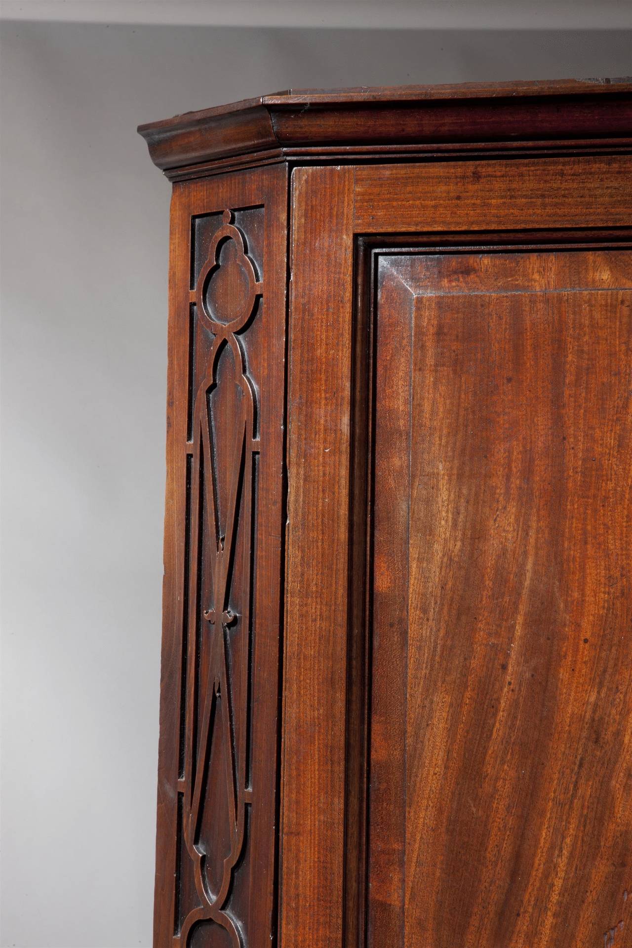 The paneled door flanked by canted edges with blind fret work 
carving (formerly with gallery).