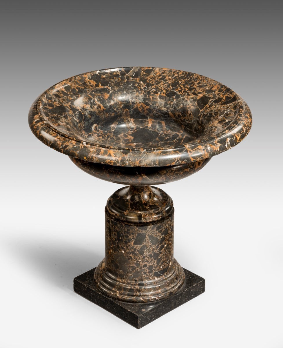 The circular bowl with a moulded lipped top supported on a centre turned column ending in a square plinth base.