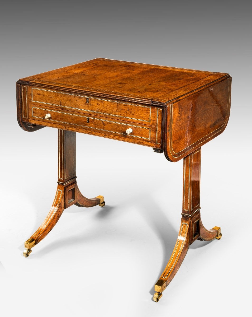 An oriental hardwood games table in the form of a sofa table. With a reversible panel top, which forms either a sofa table or a chess board. This top can be removed, slid out and slid into the fitted slots underneath, to reveal a gaming surface in