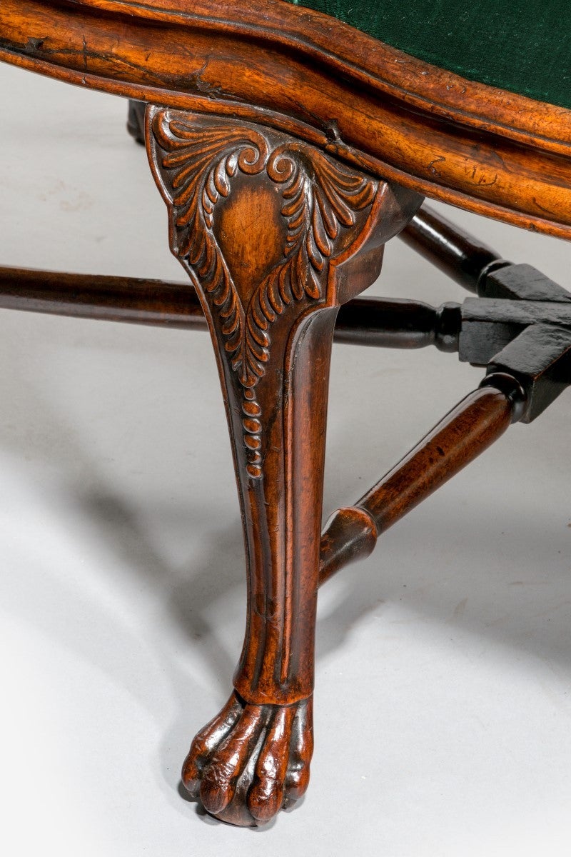 Attributed to a Chinese chair maker working in Goa, India.

The shaped top rail carved with an armorial crest depicting a bird’s head within a coronet, set above scrolled stiles with a rope-twist border. The pierced vasiform splats carved with a
