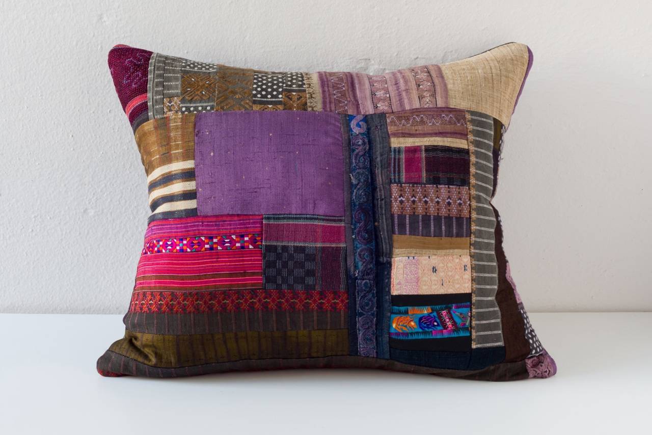 Piecework cushion composed from Huang Ping County Miao embroidery textiles, Hmong handwoven hemp and Hebei futon cover, China and a Taisho Era purple silk, Japan. 

-Coordinating linen on reverse.
-75/25 goose feather and down inserts.
-Concealed
