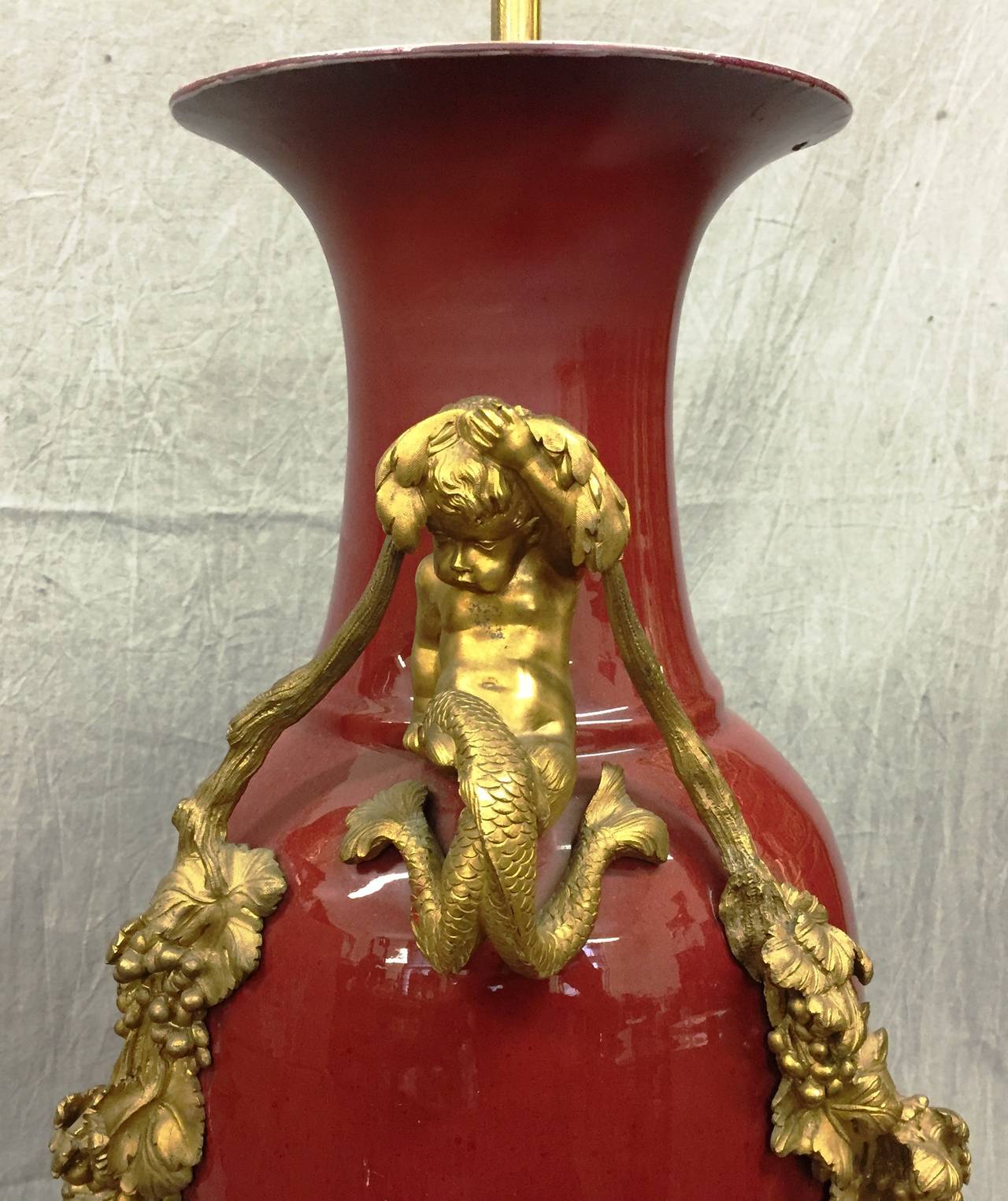 A very impressive Chinese 19th century Sang de Boeuf vase / lamp. Having wonderful French gilded ormolu mounts with C-scroll, grape vine and mermaids decoration.