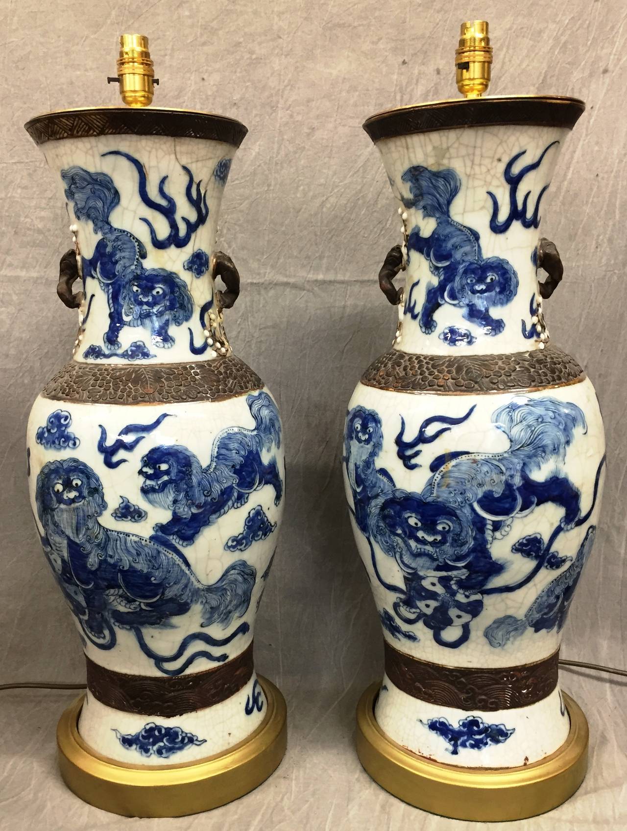 An impressive pair of Chinese blue and white crackleware vases turned lamps, circa 1900.