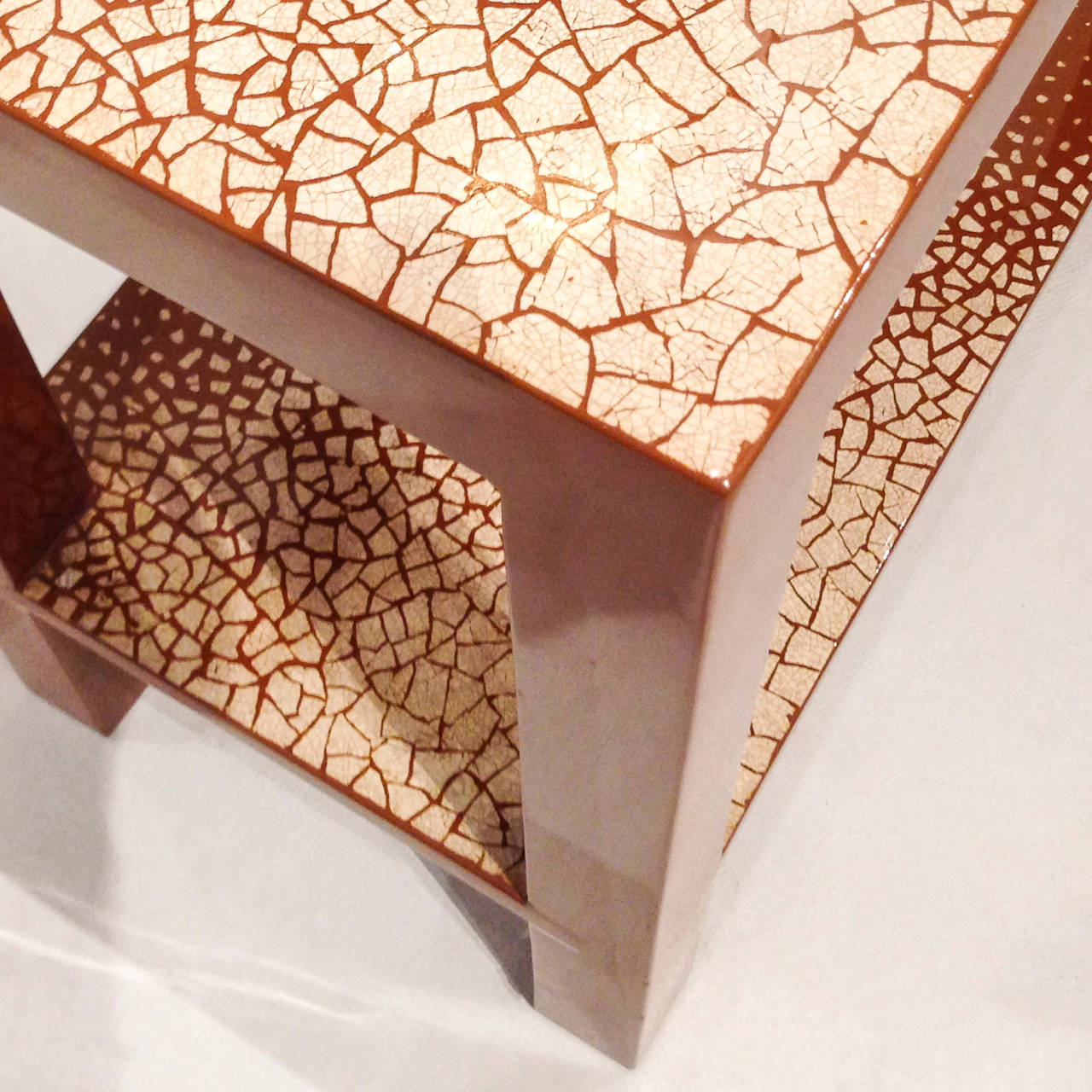 A Two Tier Parsons Style Lacquered Table With Gradient Eggshell Work In The Manner Of Jean Dunand
