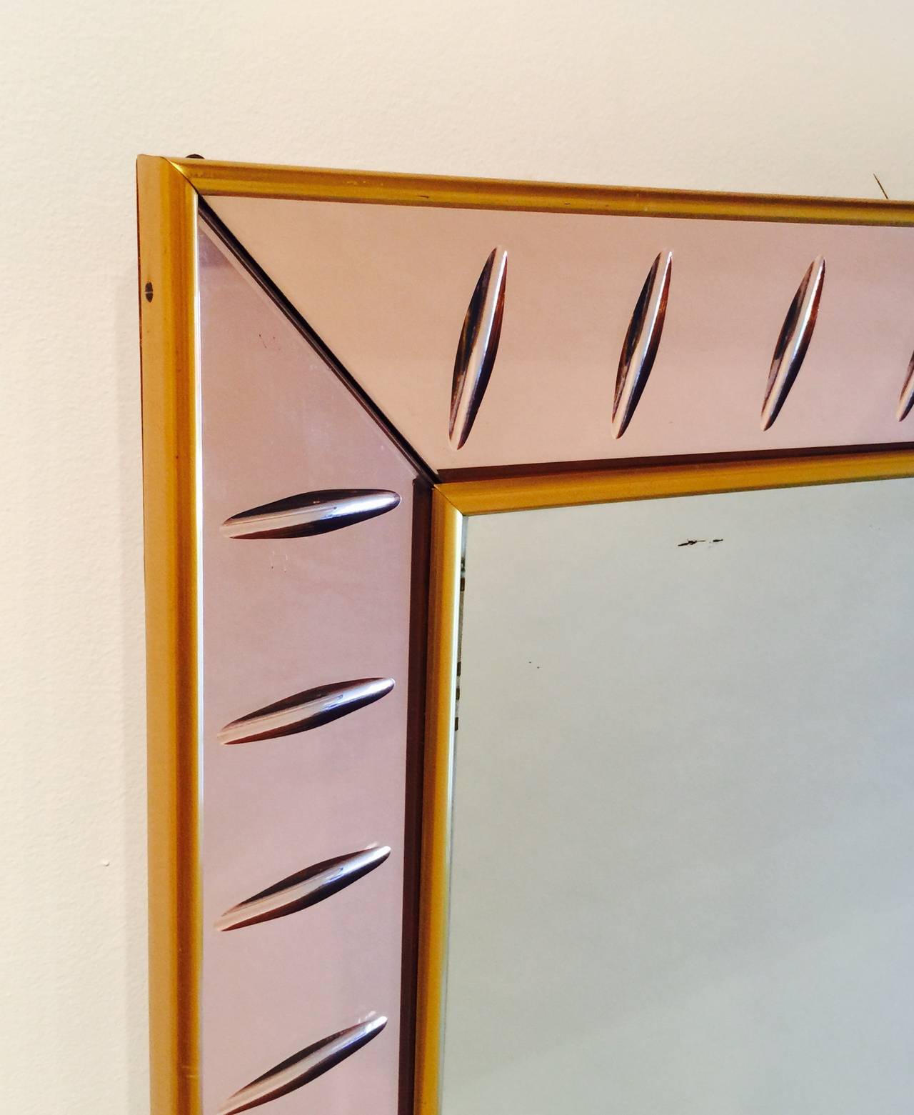 A Large Mirror With An Integrated Glass Shelf Framed In Rose Colored Mirror Resting On Wooden Feet By Cristal Art