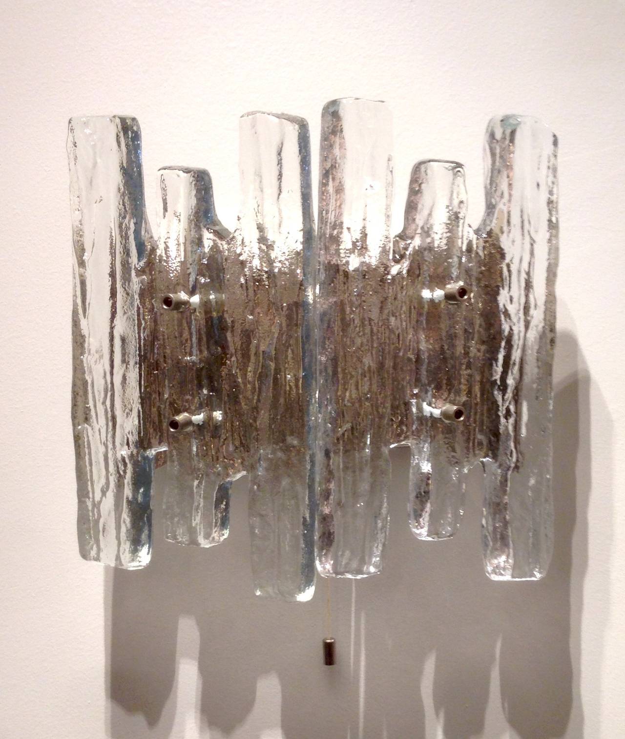 A Pair Of Three Light Sconces With Two Piece Glass Icicle Shades And Steel Backplates By Kalmar