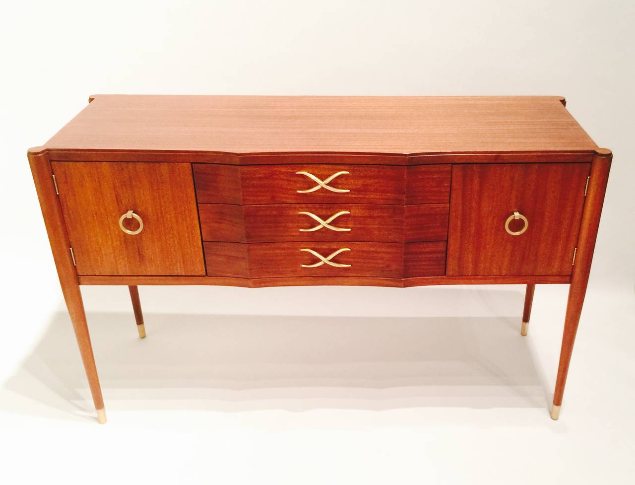 A Paul Frankl Credenza With Three Drawers Flanked By Cabinets And Set Off With Brass Hardware And Sabots