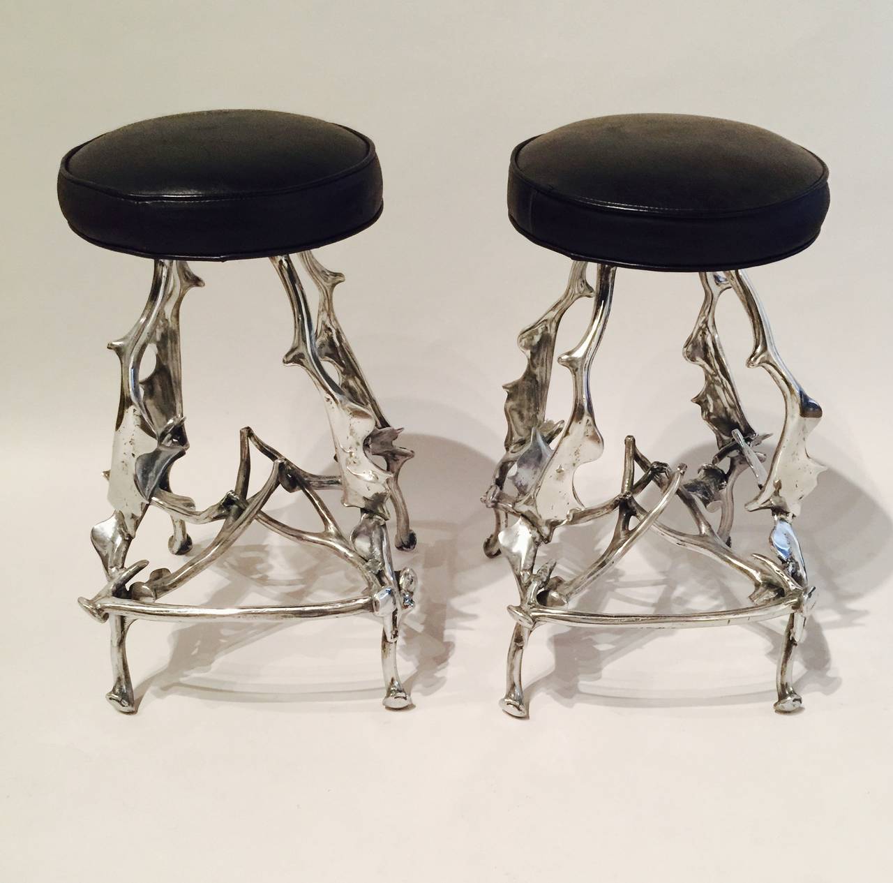 A Pair of Polished Aluminum Antler Barstools By Arthur Court With Newer Black Leather Seats (Diameter Of Seat Is 15