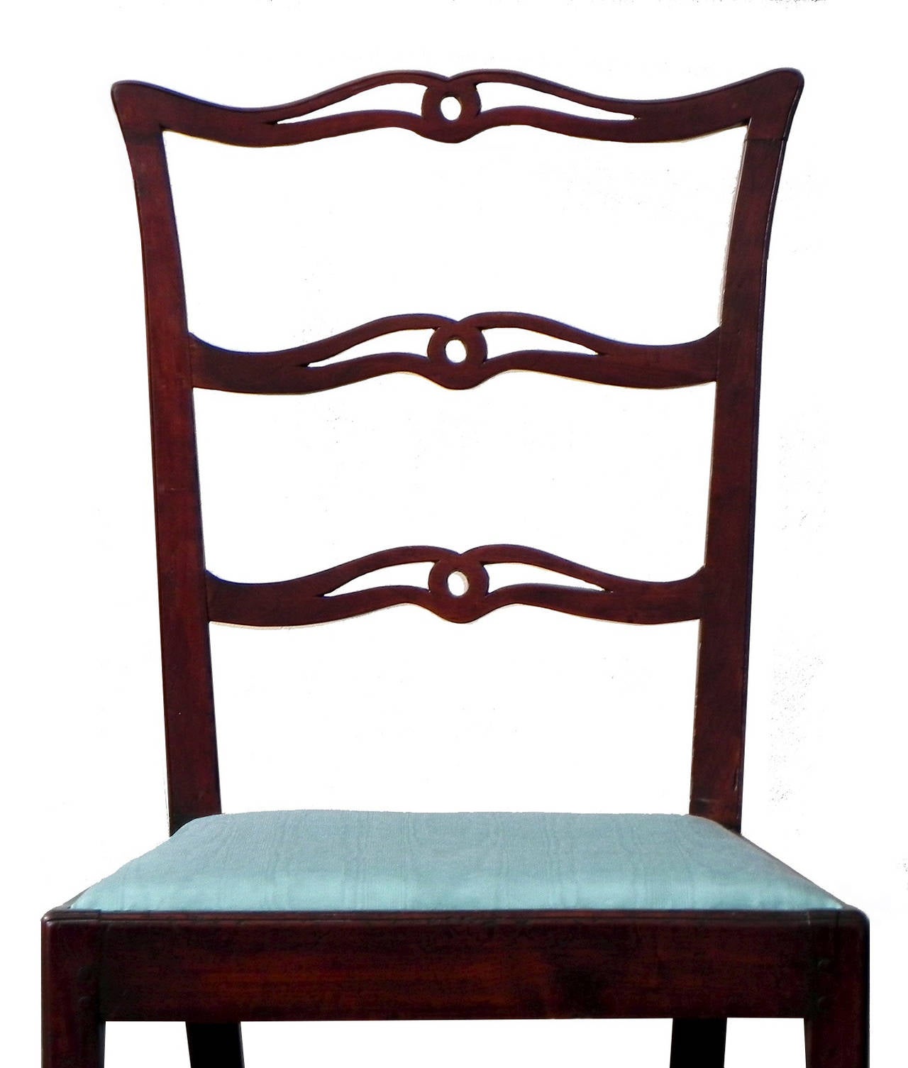The original finish of this country Chippendale set of chairs has a wonderful rubbed patina and newly upholstered slip seats. The cupid’s bow crest, stiles and shoe feature a scratch bead moulding with thumbnail moulded seat frame and legs, all