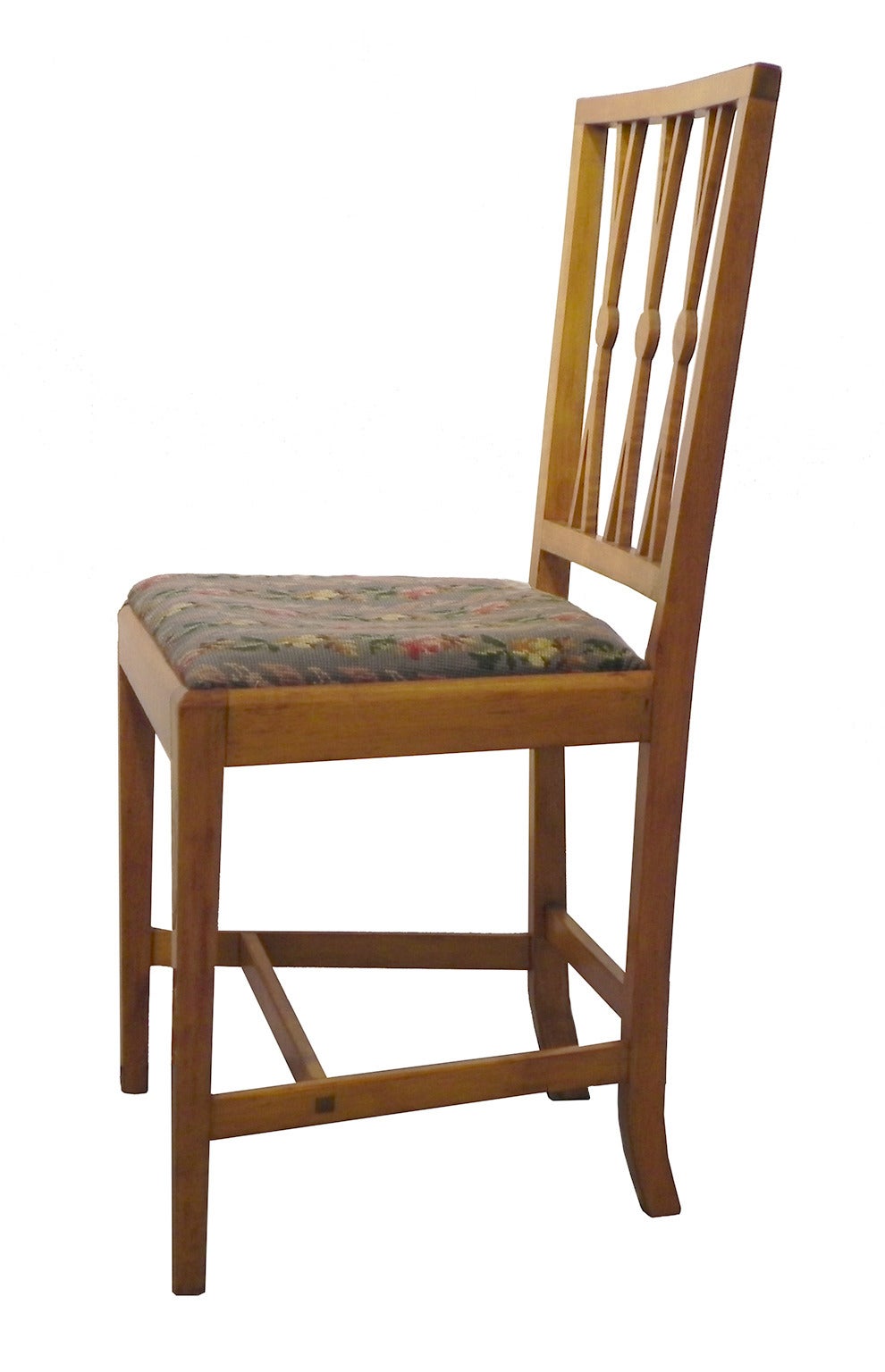 A pair of maple side chairs Portsmouth, NH having later needlepoint slip seats. The warm, medium brown tone of the wood is nicely featured with some figure to the maple on the back splats. The hand-stitched upholstery on each chair is different,