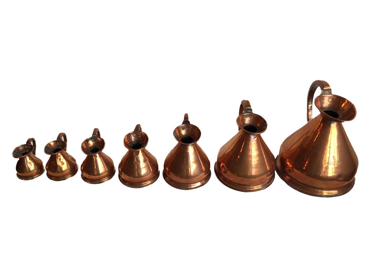 Rare Set of 7 Graduating Copper jugs. Official English Customs and Excise stamped. Circa 1870. Gallon to 1/2 Gill.