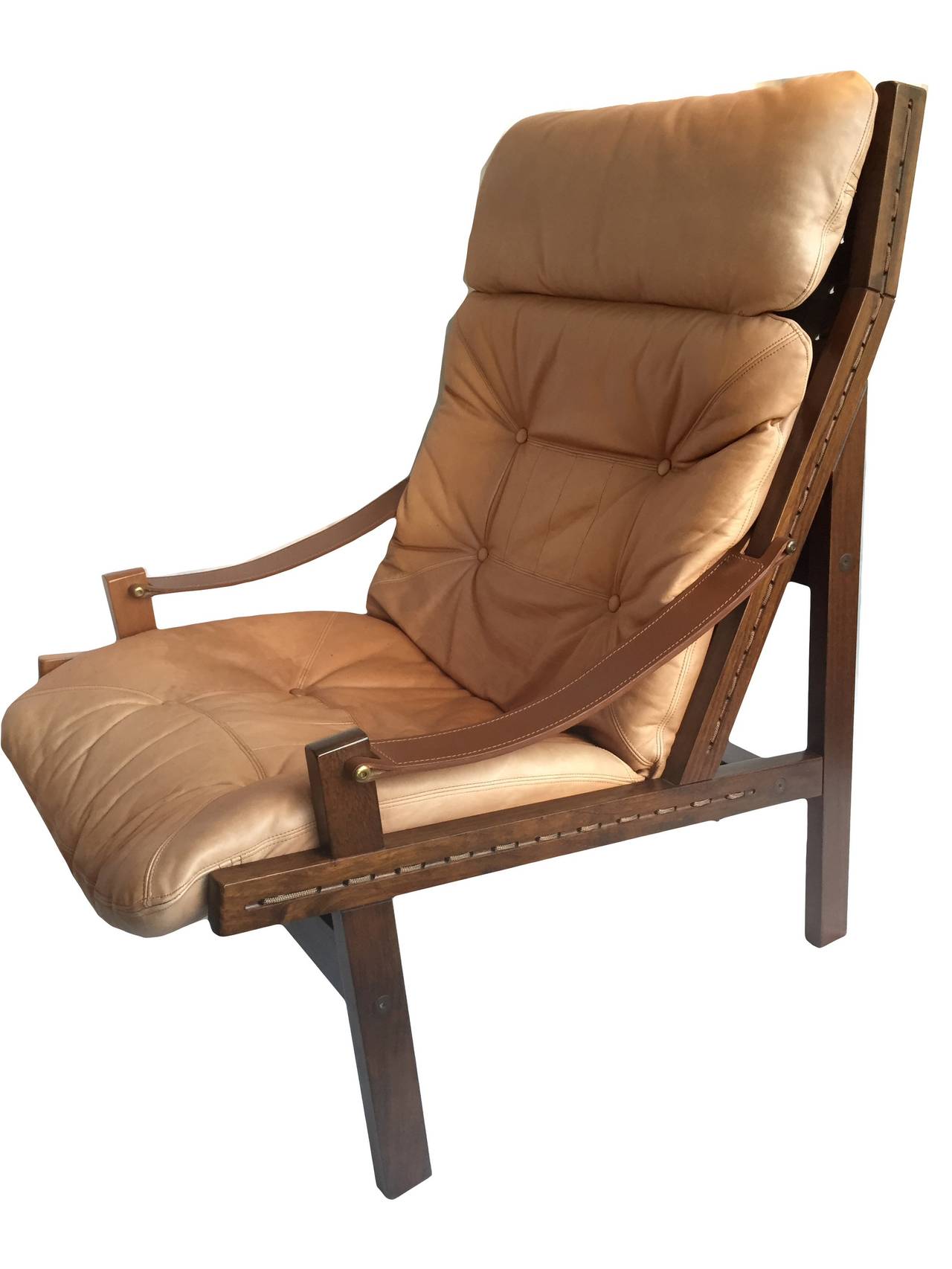 High back Hunter chair with ottoman by Torbjorn Afdal, Vatne, Norway, 1960.
Lovely walnut frame with very light tan leather upholstery. 
Another matching chair is available without an ottoman.
Easily dismantled/assembled for shipping