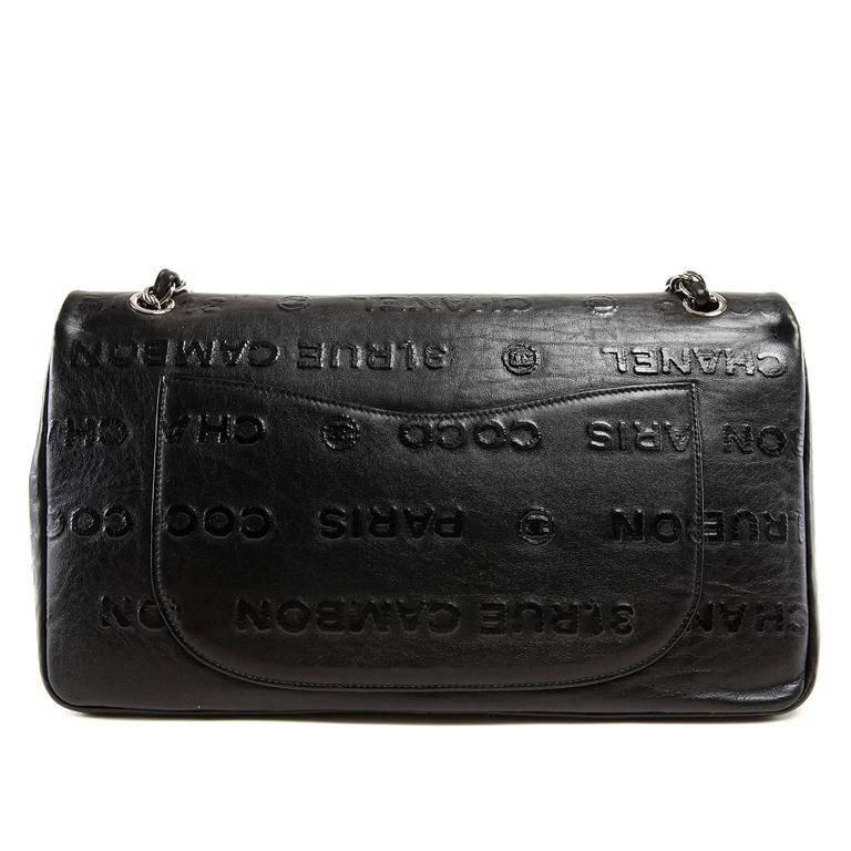 Chanel Black Leather Rue Cambon Double Flap Bag- PRISTINE; Rare Embossed in black on black with iconic Chanel words, this piece is a must have for collectors. Black leather double flap style shoulder bag is covered in raised block lettering.