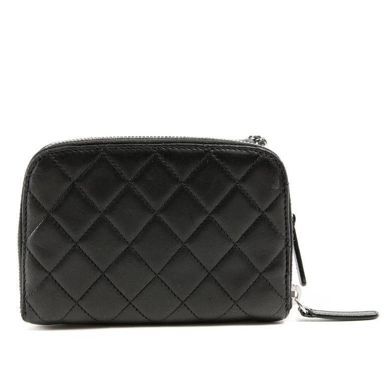 Chanel Black Lambskin Mini Flap Wallet on a Chain- PRISTINE Brilliantly combining two beloved styles, this versatile cross body is a must have. Black lambskin is quilted in signature Chanel diamond pattern. Silver interlocking CC twist clock secures
