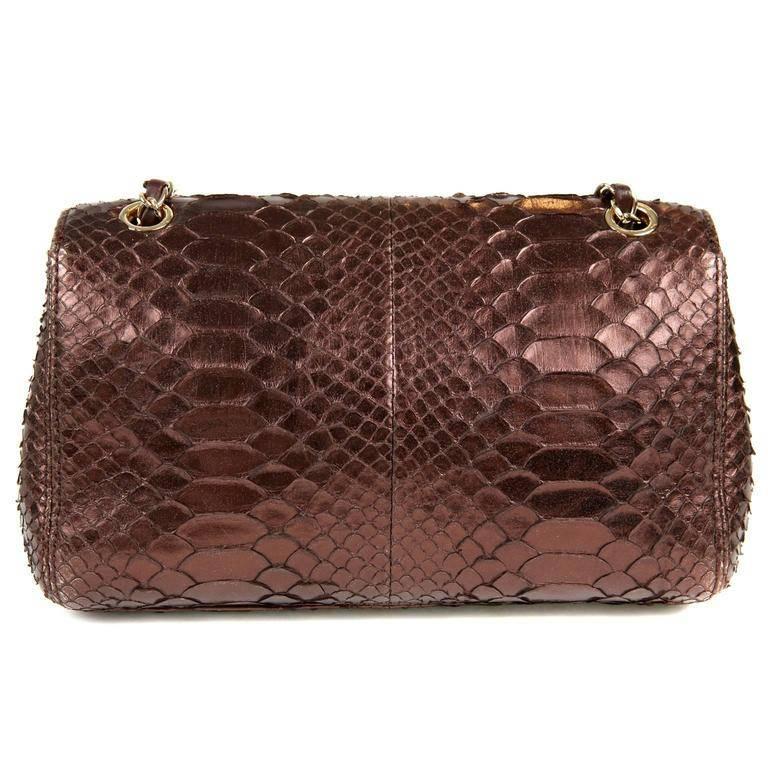Chanel Metallic Plum Python Single Flap Classic- MINT A very rare exotic from the 2010 Collection, the color and texture complement each other brilliantly. Single flap classic style in deep metallic plum python. Gold interlocking CC twist lock.