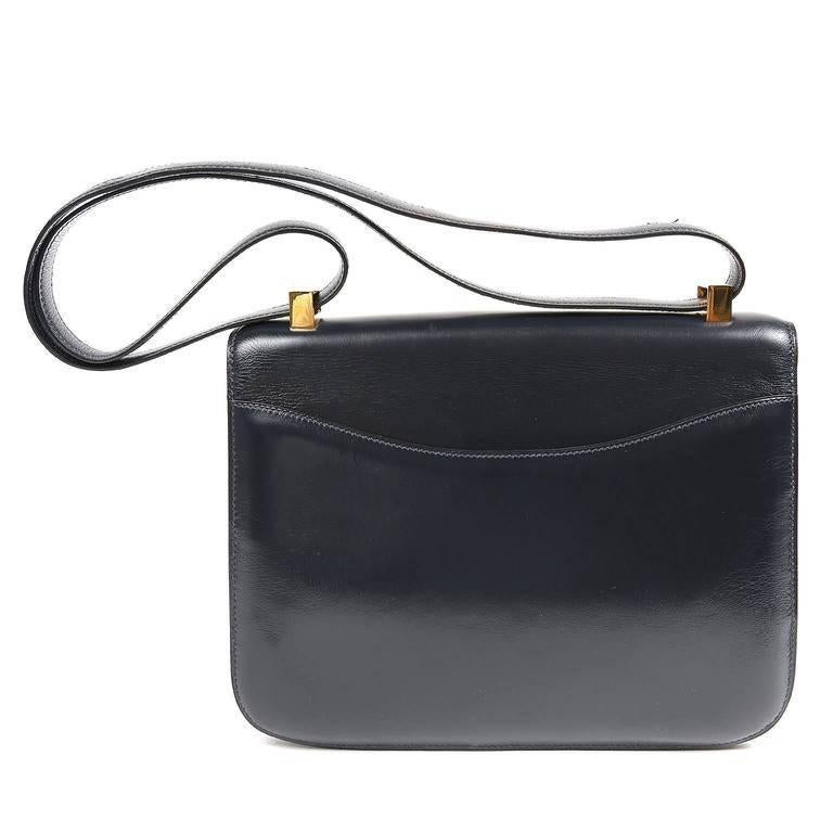 Hermes Navy Box Calf Constance- EXCELLENT The Constance is considered truly classic and highly collectible. The Constance has simple clean lines with a style that suggests an equestrian saddle bag. Worn over the shoulder or cross body, it is quite