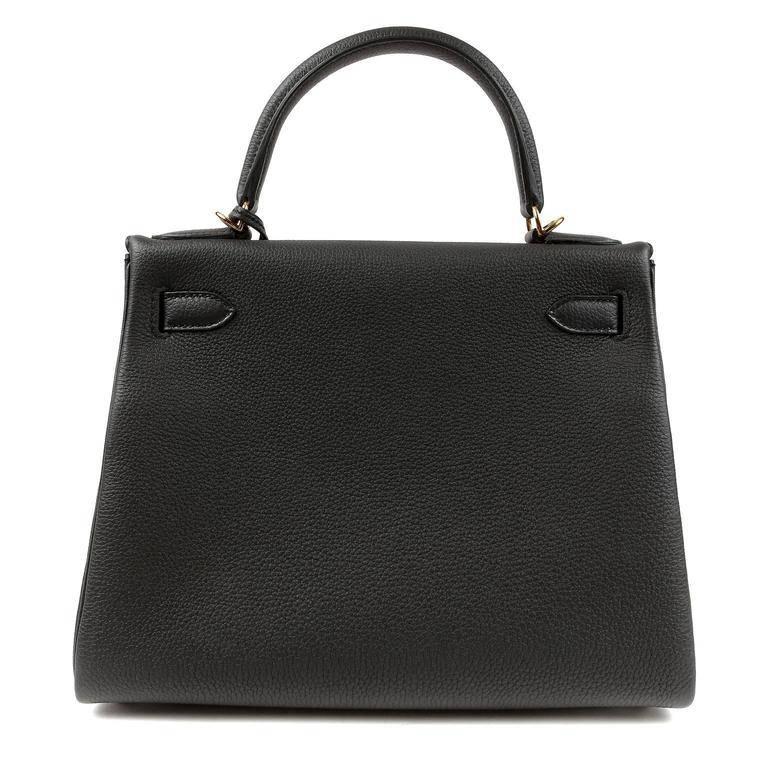 Hermes Black Togo 28 cm Kelly- PRISTINE; The protective plastic remains intact on the hardware. Hermes bags are considered the ultimate luxury item worldwide. Each piece is handcrafted with waitlists that can exceed a year or more. The ladylike
