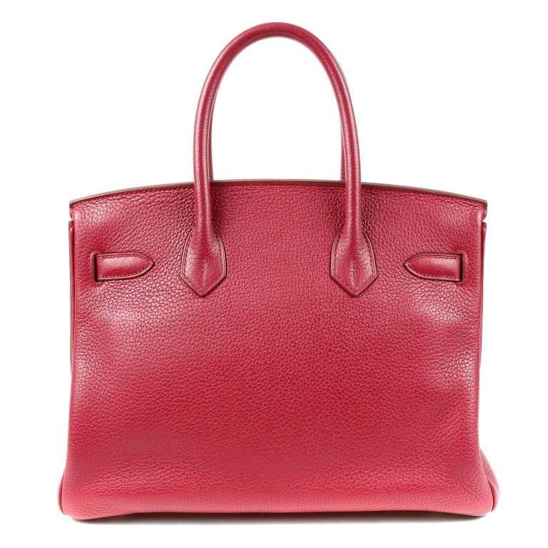 Hermes Ruby Togo 30 cm Birkin- PRISTINE, appears never carried The plastic is still intact on the padlock. Hand stitched by skilled craftsmen, wait lists of a year or more are commonplace for the Hermes Birkin. They are considered the ultimate in