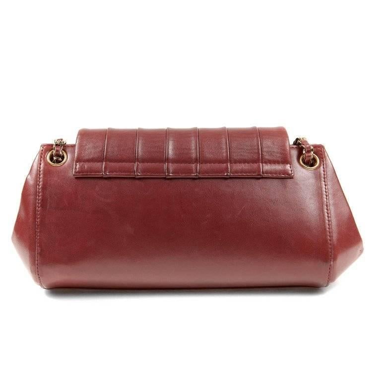 Chanel Burgundy Vertical Quilted Accordion Flap Bag- Excellent Condition A very classic shoulder bag with extra panache due to the burgundy color. Medium sized burgundy leather bag has a large front flap that is vertically quilted. Rounded corners