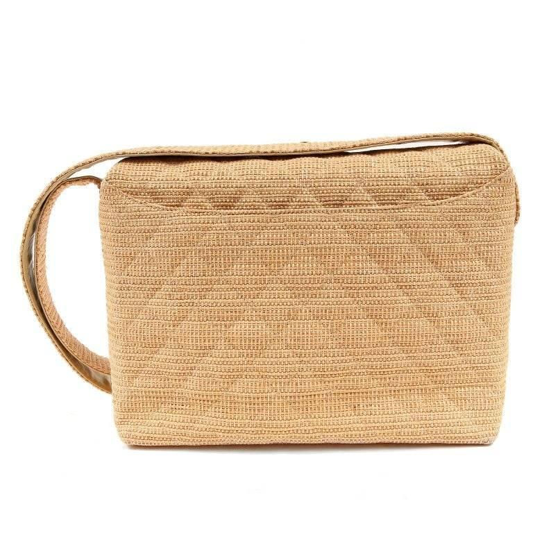 Chanel Vintage Raffia Shoulder Bag- EXCELLENT PLUS A rare style that is unmistakably Chanel and a must have for collectors. Beige woven raffia is quilted in signature Chanel diamond pattern. A uniquely placed top flap opening is secured with a gold
