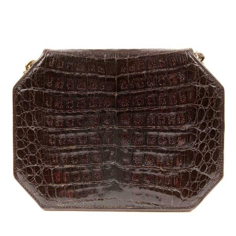 Chanel Espresso Crocodile Octagonal Bag- Excellent A rare vintage style, it is a beautiful addition to any collection. Deep espresso brown crocodile skin is structured in an octagonal shape. Gold interlocking CC twist lock secures the front flap.