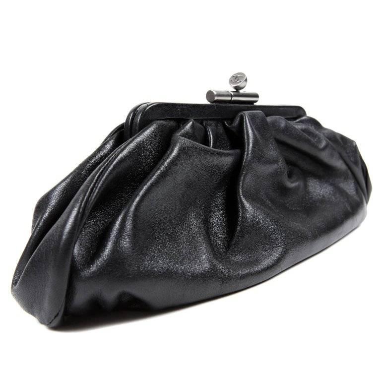 Chanel Black Lambskin Gathered Clutch- Pristine Condition An elegant black clutch is an important staple in any wardrobe. This perfectly scaled Chanel is certain to work in nearly any circumstances. Soft black lambskin is gently gathered with