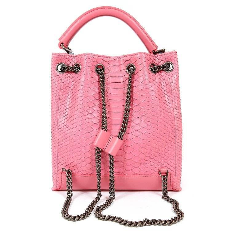 Chanel Pink Python Backpack- Pristine, NEVER CARRIED. A fabulous exotic that stands out in a sea of black, the pop of pink is superbly amplified by the texture of the python. Bubblegum pink python skin traditional backpack has edgy ruthenium