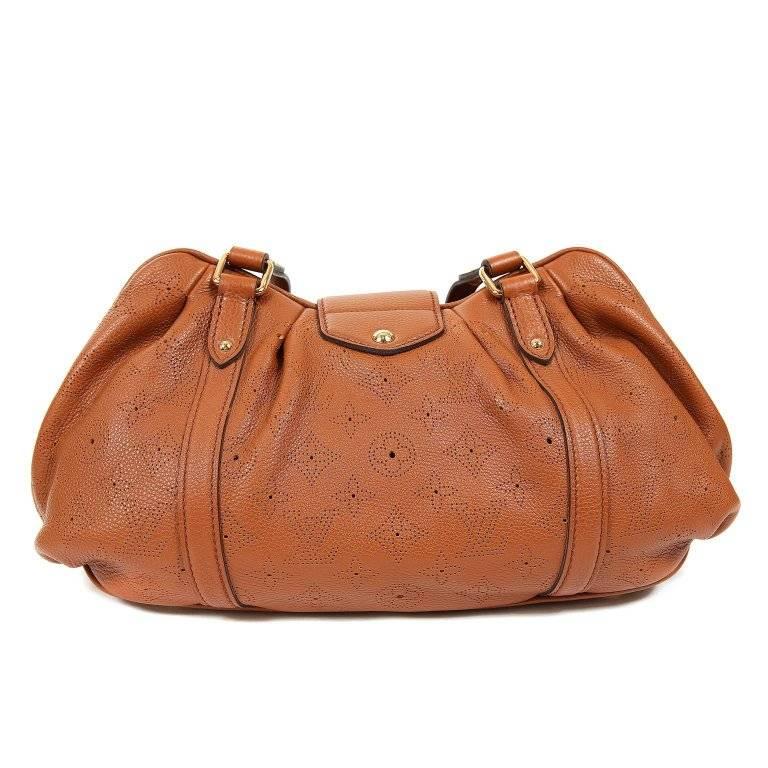 This authentic Louis Vuitton Cognac Mahina Leather Lunar PM is brand new. A fantastic find, the Lunar is stylish and spacious. It is easily carried every day in year-round neutral Cognac. Warm cognac grainy leather is subtly perforated with the