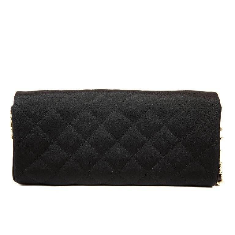 Chanel Black Crystal Embellished Evening Bag- PRISTINE Simple and striking at the same time, this elegant Chanel is perfect for any formal occasion. Black fabric is quilted in signature Chanel diamond pattern. Circular crystal and faux pearl flower