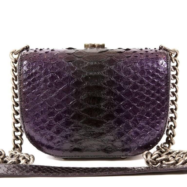 Chanel Purple Python Cross Body Bag- PRISTINE This exquisite exotic is a collectible piece and certain to hold its value. Deep purple python small structured bag has edgy ruthenium framing and CC clasp. Opening at the top, the purple fabric ling is