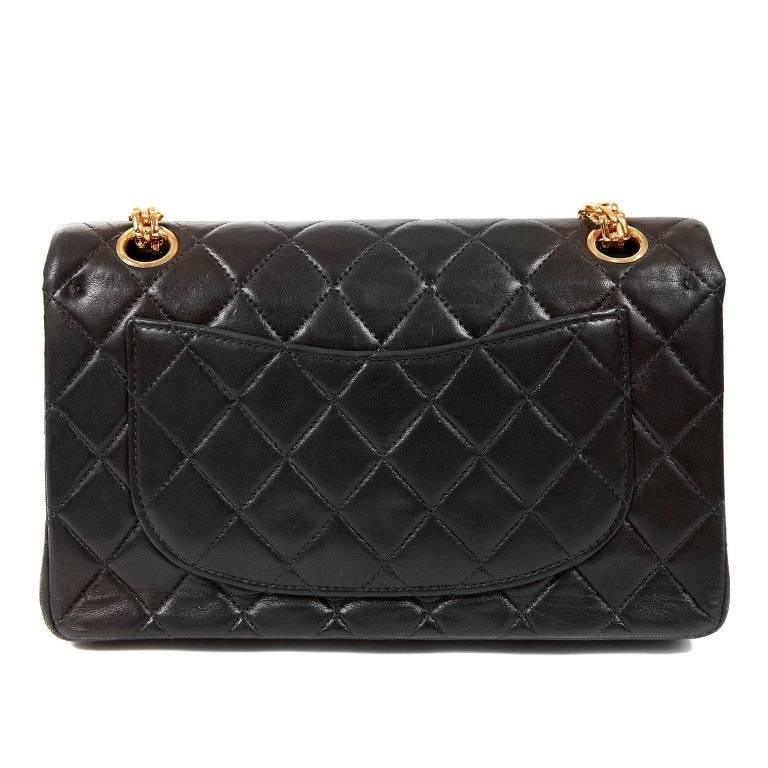 Chanel Black Lambskin 2.55 Medium Reissue Bag- EXCELLENT PLUS 24K gold plated hardware accents makes this beautiful piece particularly special. Black lambskin is quilted in signature Chanel diamond pattern. 24k gold mademoiselle twist lock on