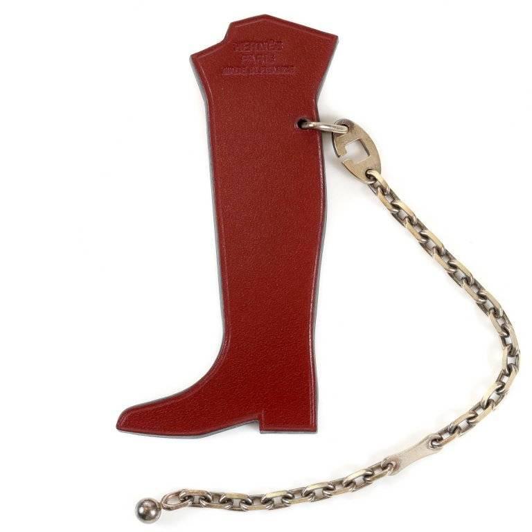 Hermes Hotte Botte Leather Keychain- MINT condition with the original box Burgundy veau box equestrian boot is stuffed with colorful gifts. Silver tone chain attaches to a bag or keys. Rare, iconic and collectible. Made in France. A197