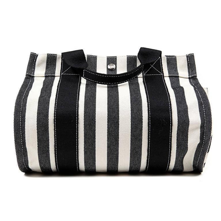 Hermes Black and White Striped Canvas Tote- PRISTINE The cheerful summertime carryall is accompanied by a coordinating black canvas case. Black and cream striped canvas tote is carried in hand or at the elbow by double handles. Rounded bottom