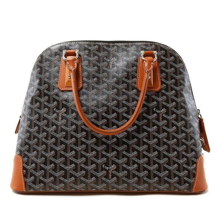 Goyard Black Vendome Bag- RARE! In Pristine Condition Unique design elements make this collectible piece very striking. Black chevron Goyard monogram canvas domes satchel is accented with warm cognac brown leather and wooden trim pieces. Silver tone