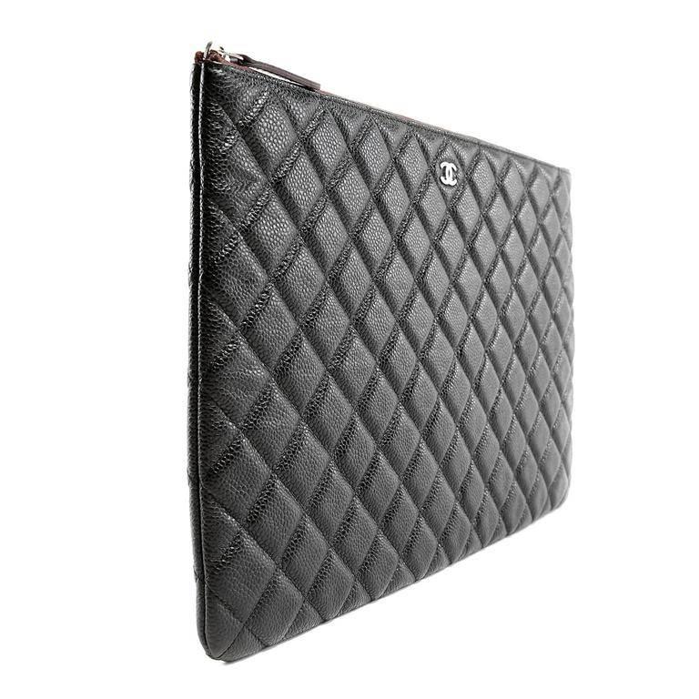 Chanel Black Caviar Leather Portfolio is pristine. A stylish carryall for folders or tossed inside a larger bag, this is a smart unisex item. Durable and textured black caviar leather is quilted in signature Chanel diamond stitched pattern. The slim