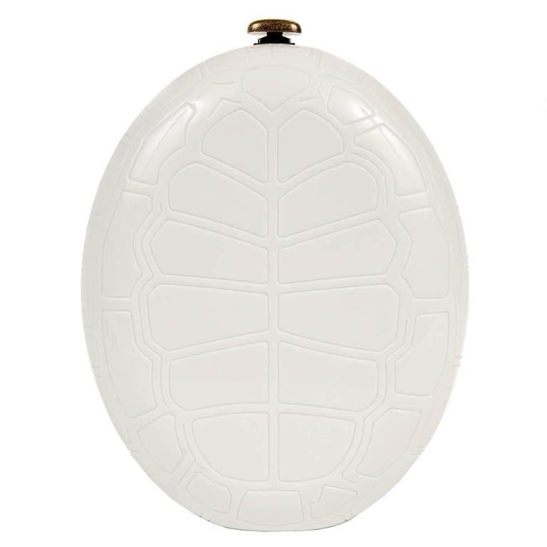 Chanel Ivory Turtle Shell Print Bag is from the 2016 Cruise Collection. It is pristine. Original retail $12,000.00. 
 Ivory resin oval is imprinted with turtle shell pattern. 
Antiqued gold hardware accents and extra- long chain strap. Press lock
