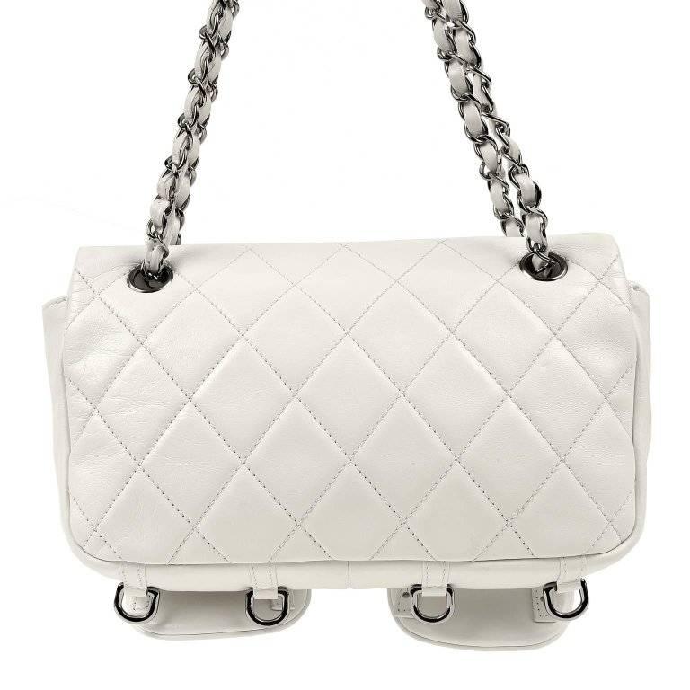Chanel White Lambskin Two Pocket Day Bag- PRISTINE A beautiful style with pronounced stitching and prominent silver hardware, this piece is hard to resist. Snowy white lambskin is quilted in signature Chanel diamond pattern. Two large patch pockets
