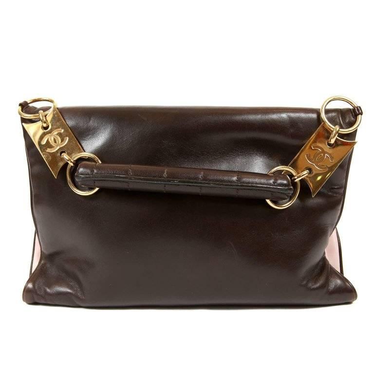 This authentic Chanel Pink and Brown Leather Handle Clutch is a very unique piece in pristine condition. Two tone coloration, two separate flap closures, chocolate bar stitching and mademoiselle twist locks set this collectible style apart.