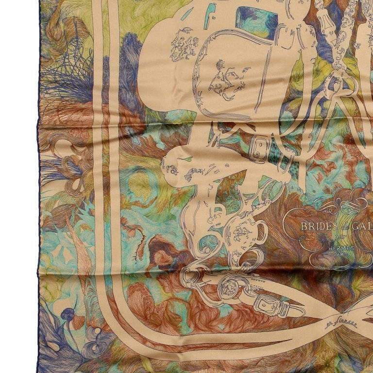 This authentic Hermes Brides de Gala en Finesse 90 cm Silk Scarf is pristine. Originally issued in 1957 and designed by Hugo Grygkar, it has been reissued multiple times. Equestrian themed featuring saddles, belts and stirrups. Neutral colorway. A210