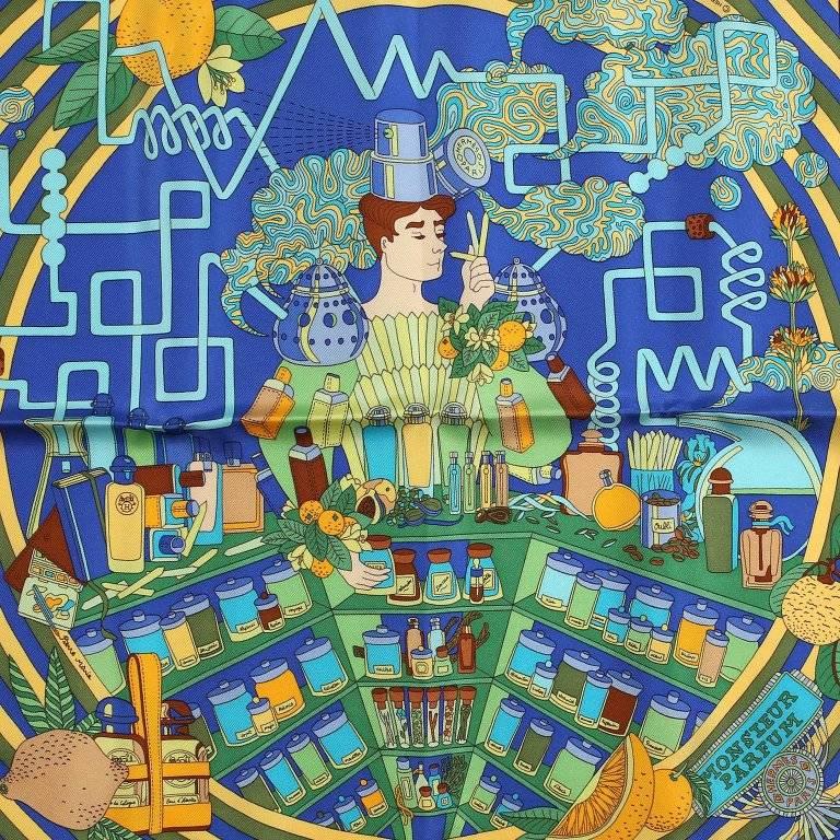 Dieser authentische Hermes Monsieur Parfum Silk Pochette Scarf ist neu. Entworfen von Pierre Marie im Jahr 2011. Blauer Hintergrund kennzeichnet einen Mann:: der aus Parfümprobenstöcken besteht. Den Duft verschiedener Blumen:: Früchte und Kräuter in